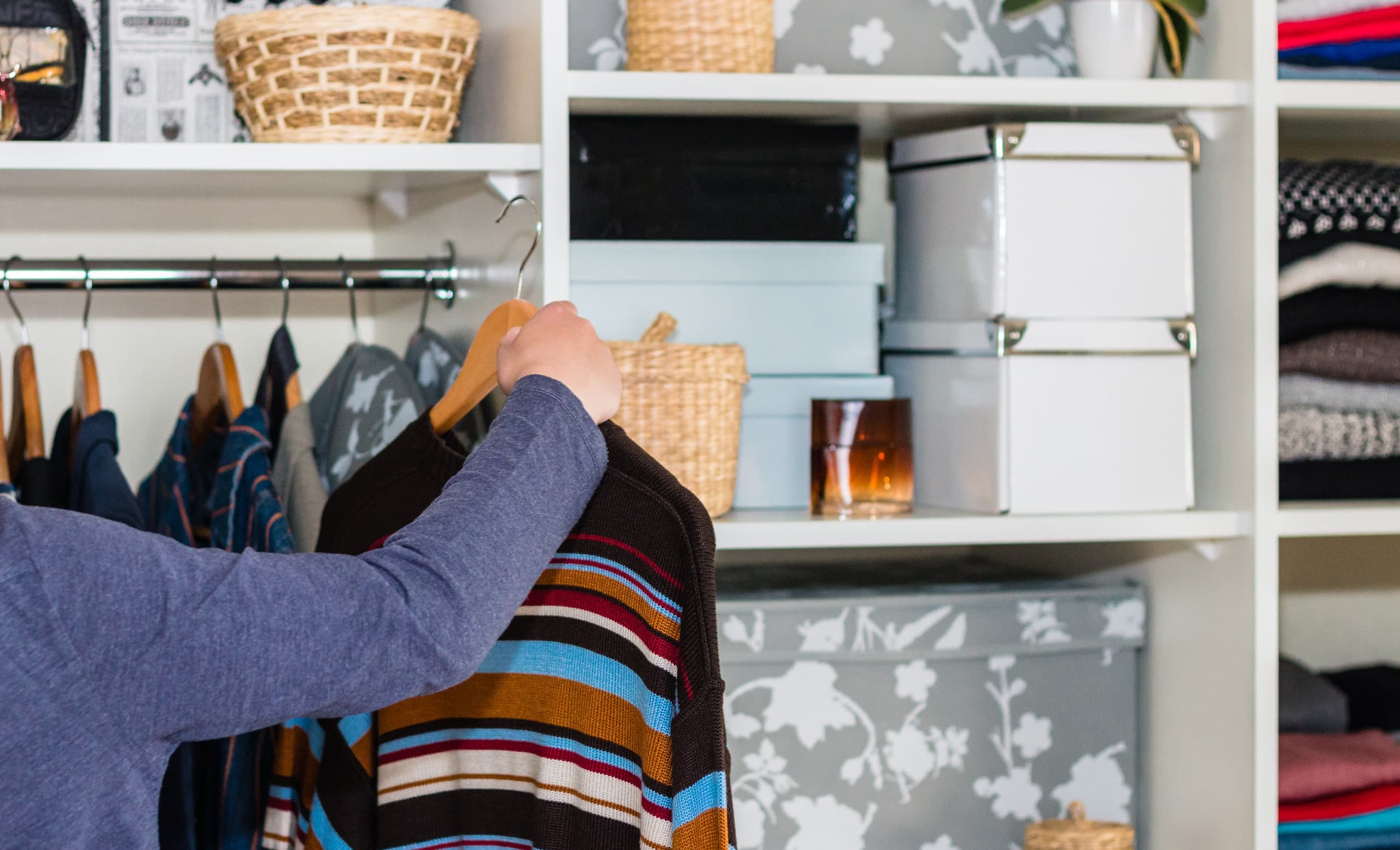 Woman looking at clothes in their closet for an insurance claim